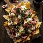 charcuterie nachos on rustic wood board