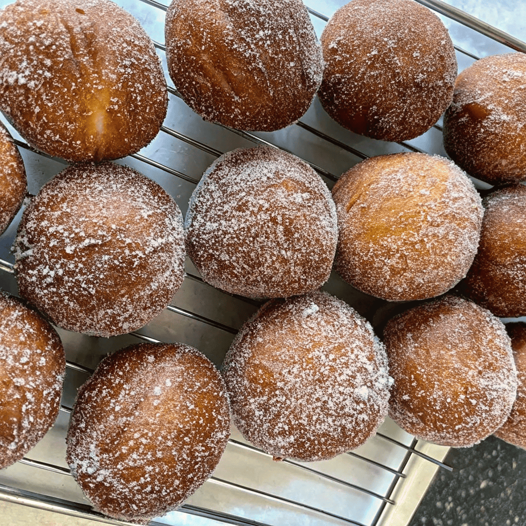 Freshly fried Taco Bell Cinnabon Delights cooling on a wire rack